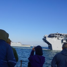 a group of people standing next to a body of water