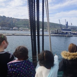 a group of people standing in front of a body of water