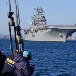 a group of people on a boat in a large body of water