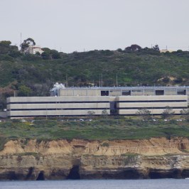a bench next to a body of water with a mountain in the background