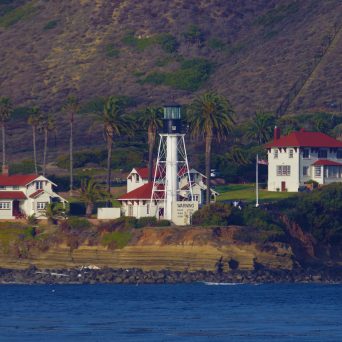 a large body of water with a mountain in the background