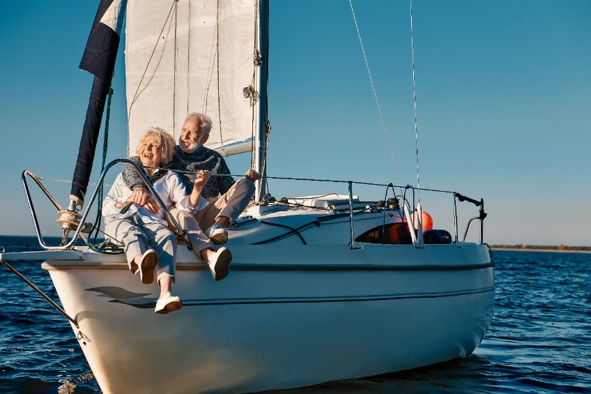 older couple on the front of a sailboat