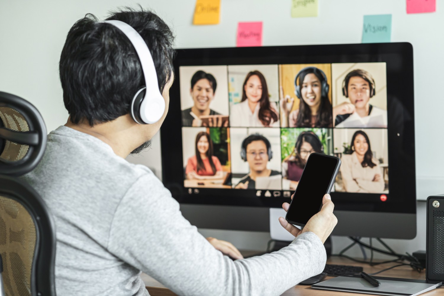 a group of people posing for a photo in front of a computer