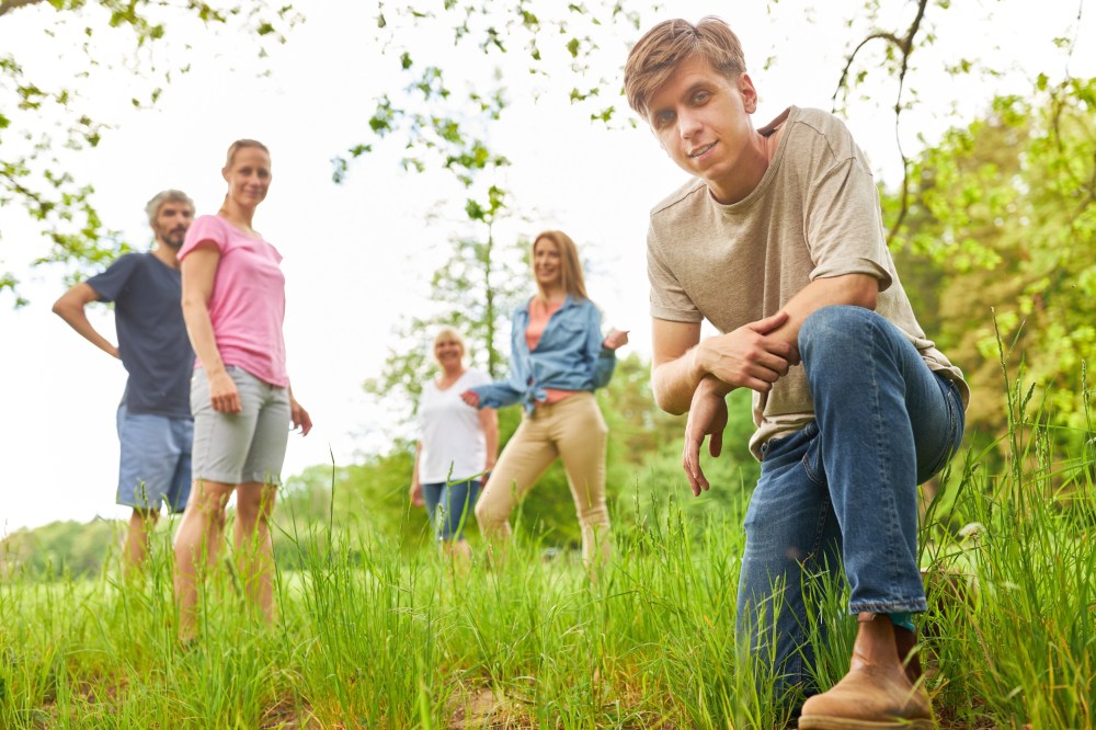 a couple of people that are standing in the grass