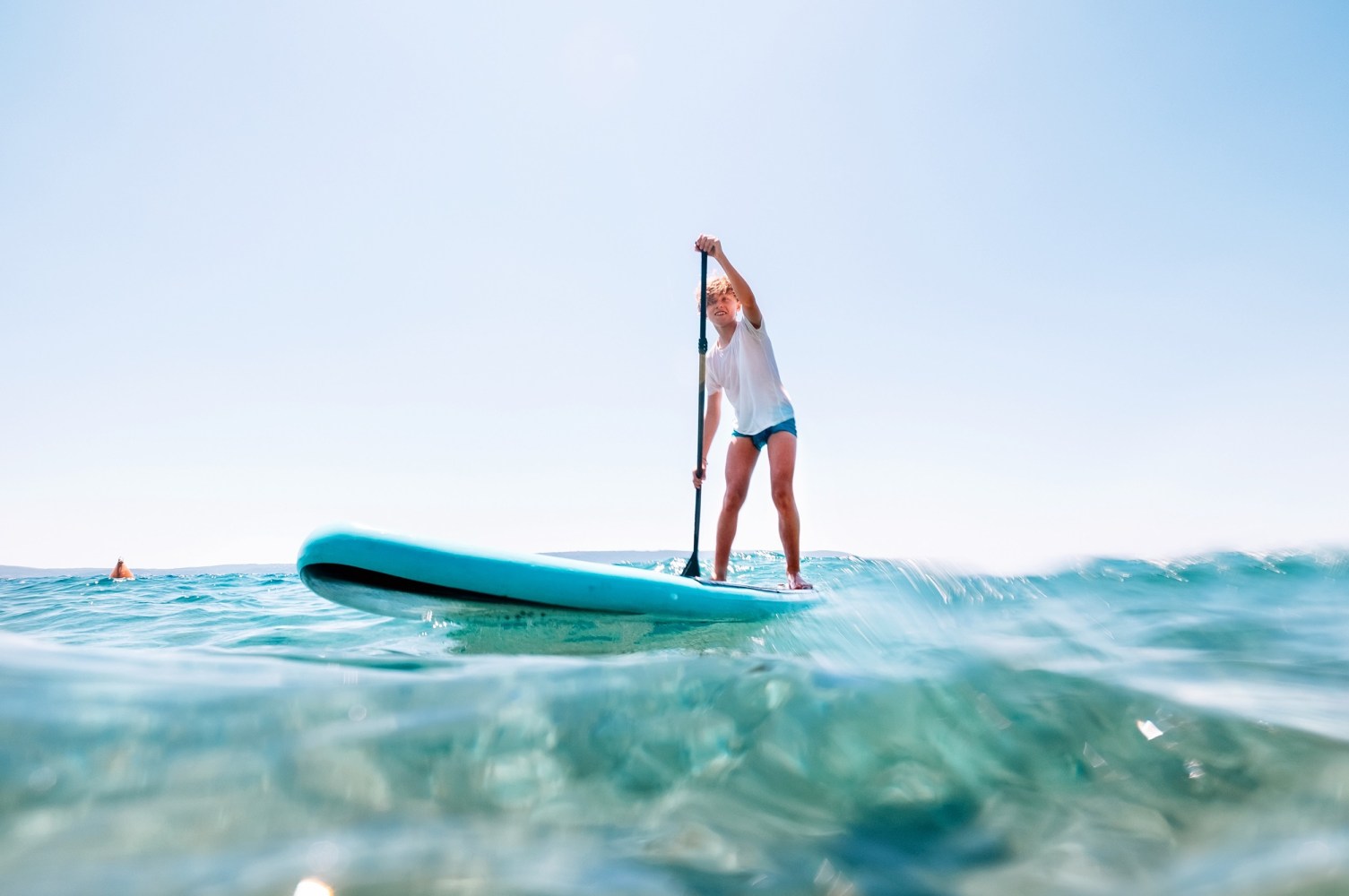 a girl riding a wave on a surfboard in the ocean