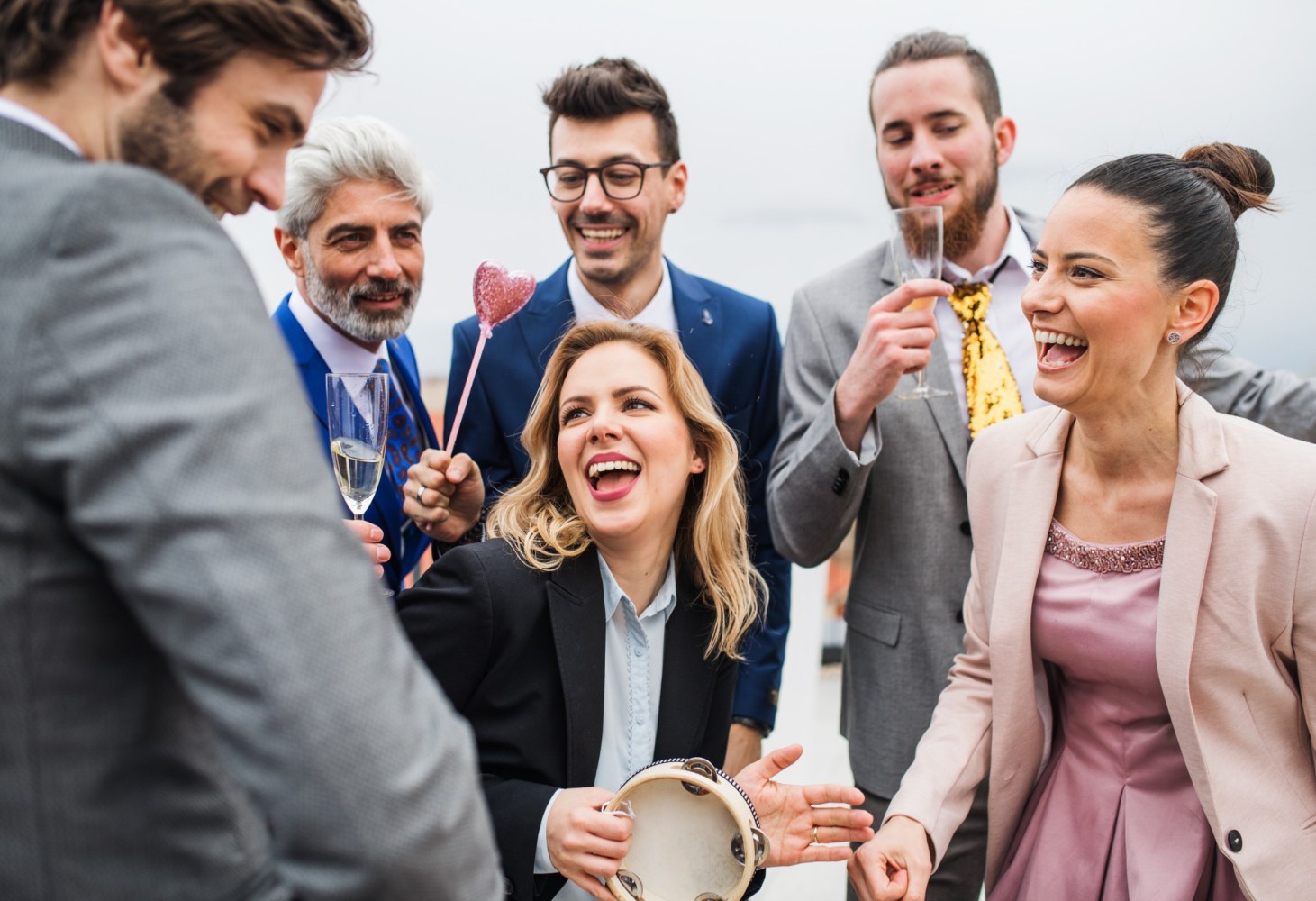 a group of people holding wine glasses
