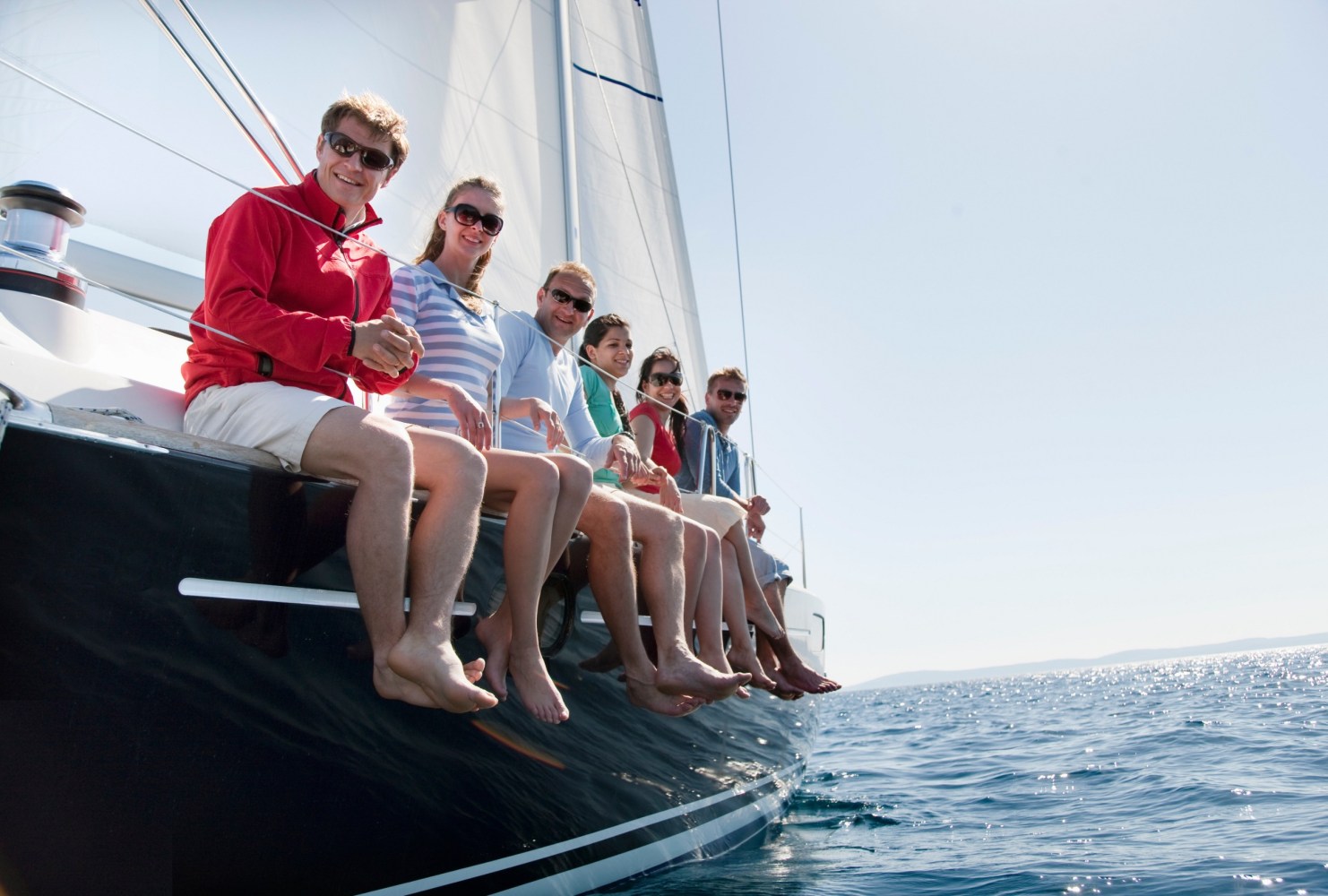 people sitting on a sailboat 