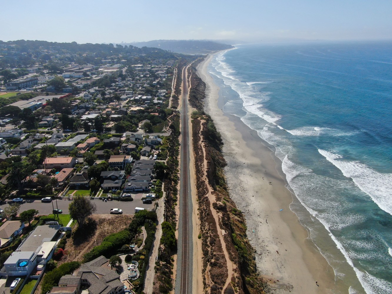 Aerial view of a Del Mar coastal road between a beach and residential area.